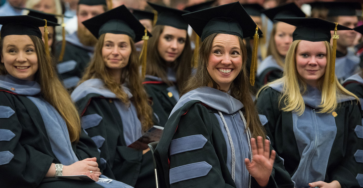 happy graduates at graduation ceremony