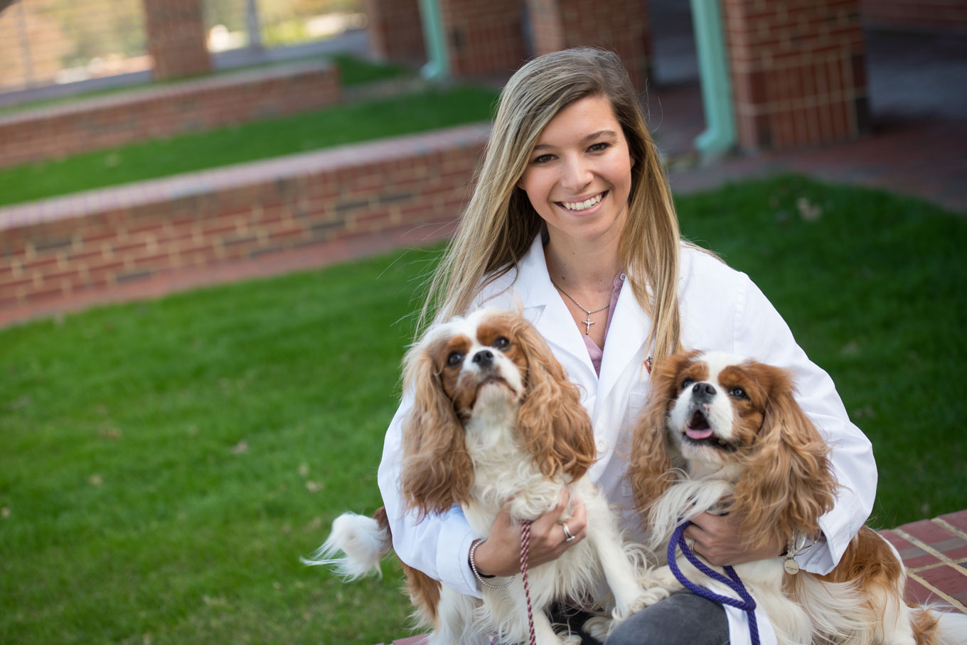Courtney Rousse Sparks holding two spaniels