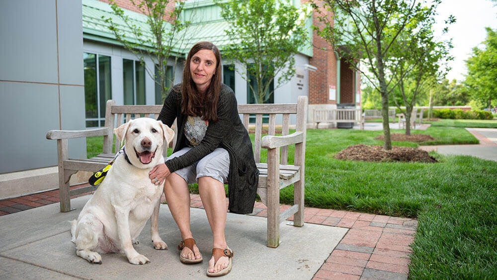 Lori Wooten pets her dog Max