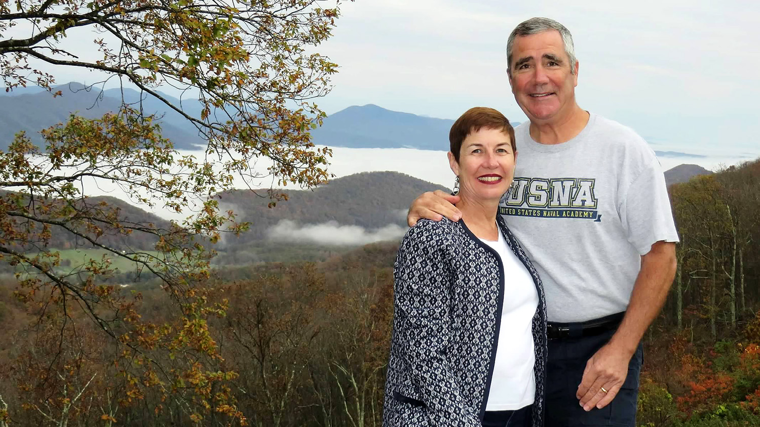 couple posing with mountain range