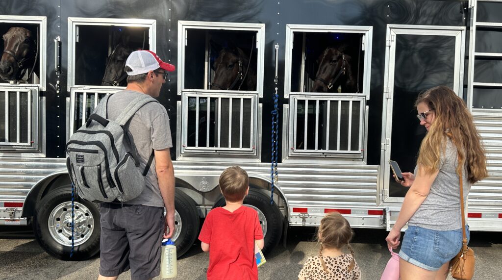 The Taylor family from Sanford, North Carolina, check out the horses from the NC Trooper Association's Caisson Unit.