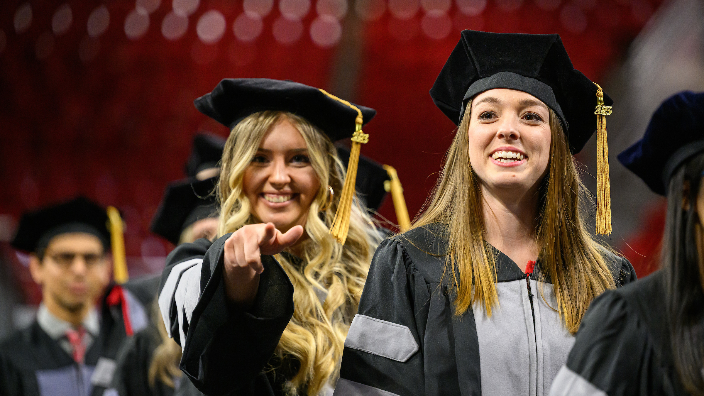 Two graduates at the 2023 Oath and Hooding Ceremony.