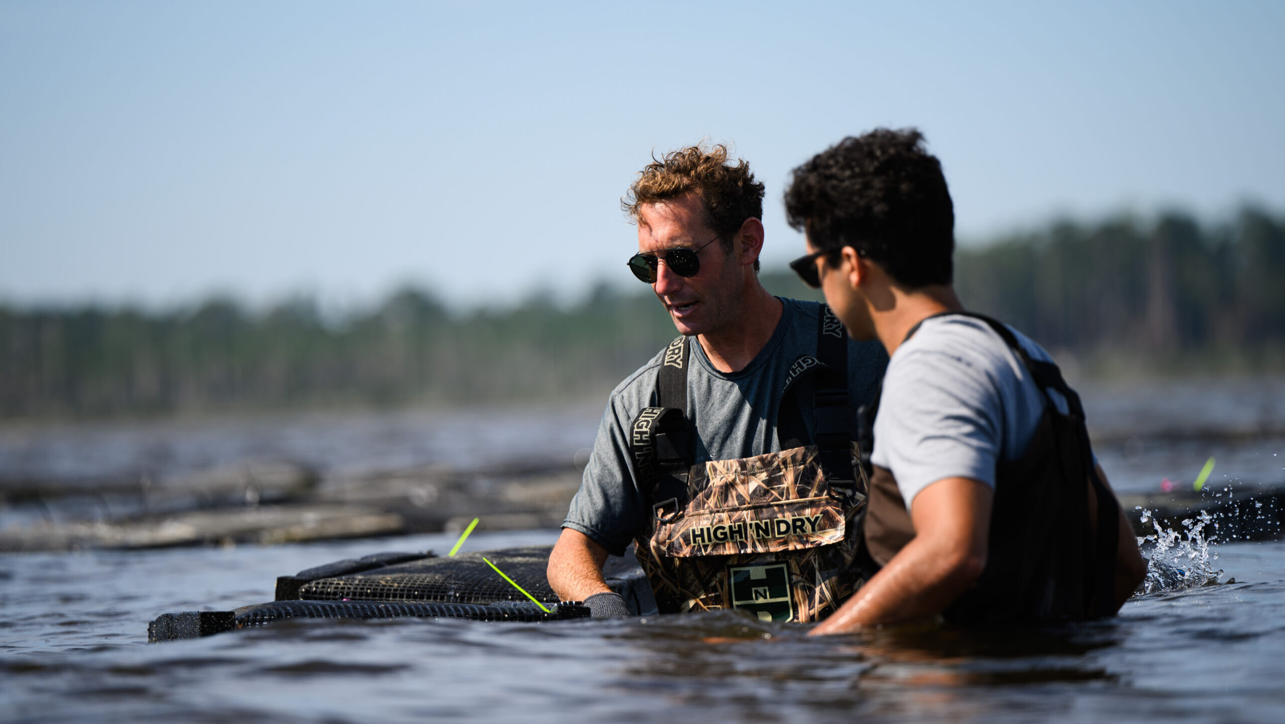Dr. Tal Ben-Horin and PhD student Zakir Bulmer relocate a set of oyster bags from CMAST to Core Sound as part of a study into the disease resistance of different genetic lines of oysters.
