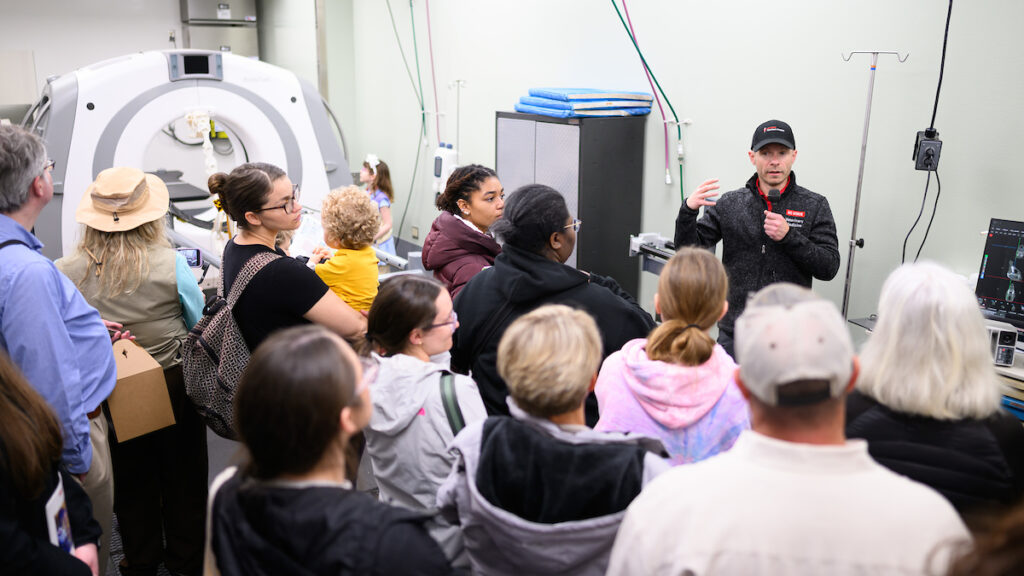 Dr. Timo Prange explains how the standing equine CT works to a crowd of Open House visitors.