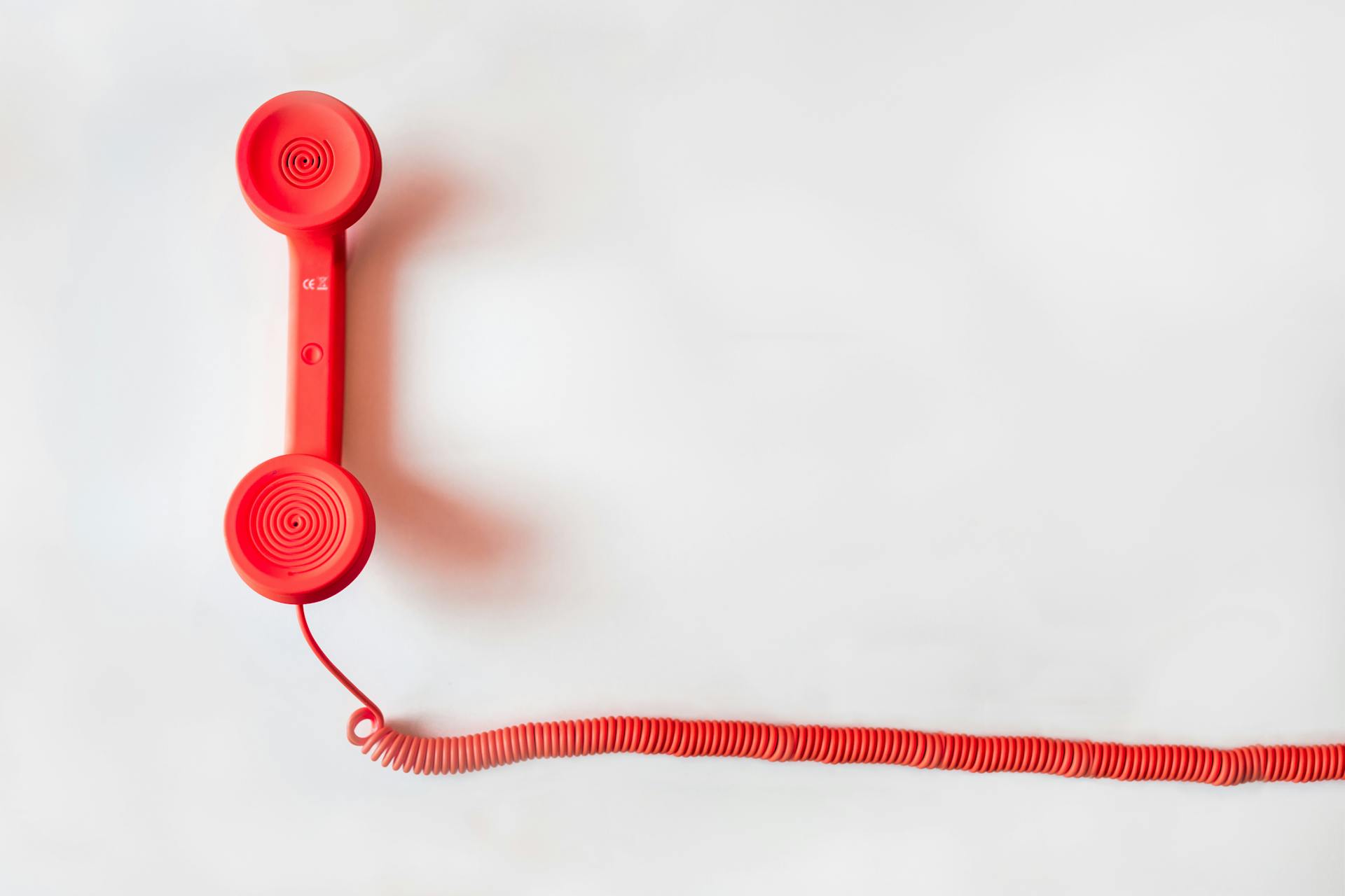 red old style phone on white background