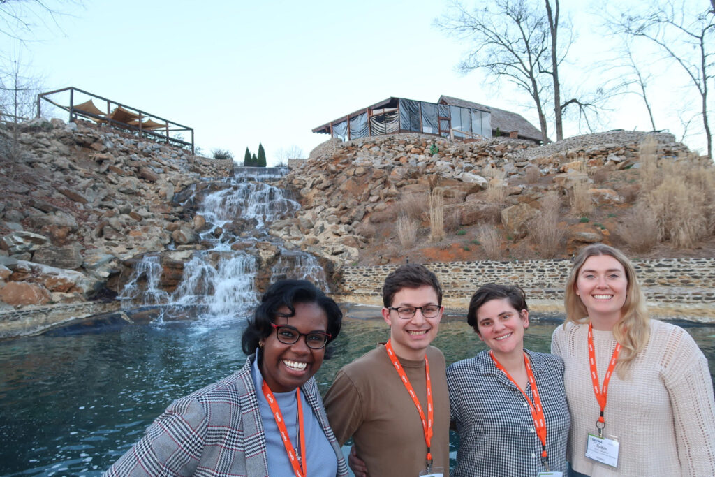 NC State SAVMA board members Anna Jones, Max Seda, Mary Emfinger and Robin Gallagher pose in front of a decorative waterfall at the 2024 SAVMA Symposium.