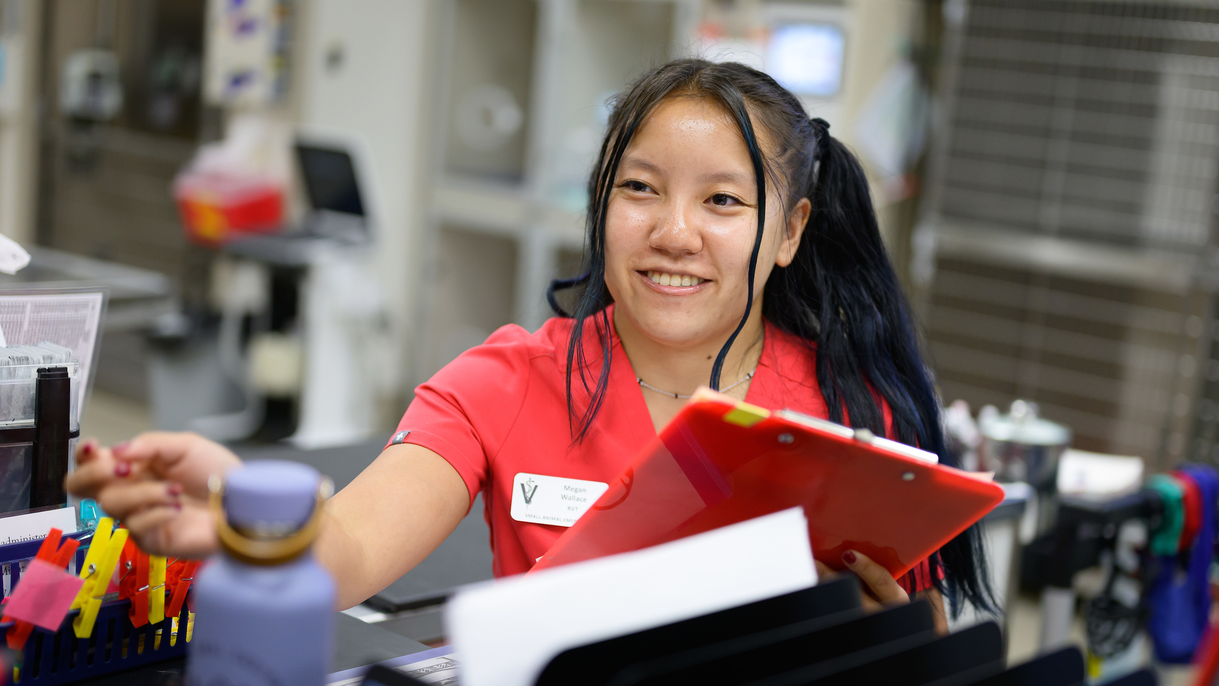 Megan Wallace, a first-year DVM student at the NC State College of Veterinary Medicine, holds a clipboard in the Veterinary Hospital's ER.