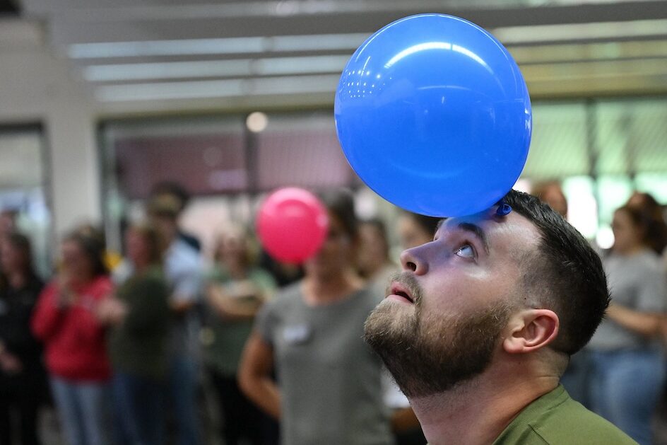 Students try to keep balloons in the air without using their hands.