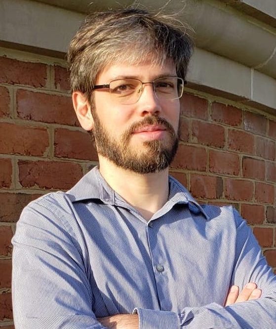 Dr. Julio Belmonte, blue shirt, brown beard, glasses